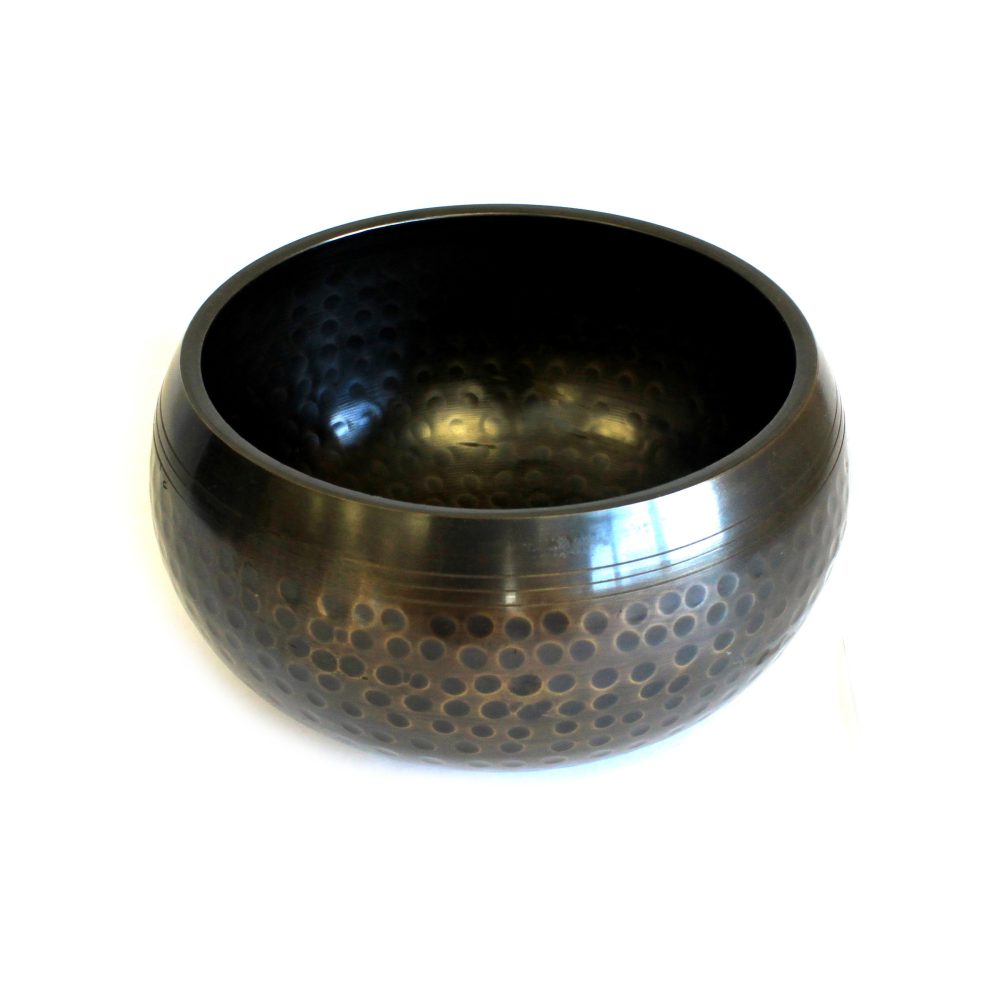 A round, dark bronze bowl with a textured, dotted pattern on the outer surface sits on a plain white background. Its interior is smooth and polished.