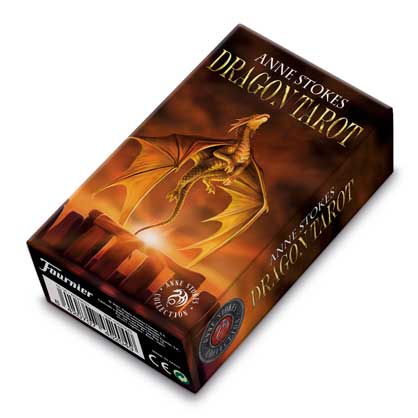 A boxed Anne Stokes Dragon Tarot deck displays a golden dragon with outstretched wings soaring over fiery ruins, angled on a white background; visible text: ANNE STOKES DRAGON TAROT