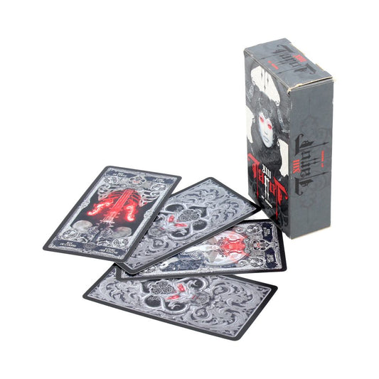 A tarot-style deck of four ornate black-and-gray cards fanned across a white surface with red highlights beside a standing dark box featuring a pale masked face; text on packaging not legible.