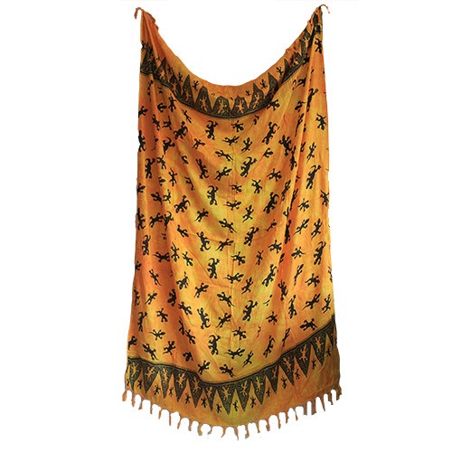 A rectangular orange textile hangs, displaying a pattern of black lizards. The fabric has tassels at its hem.