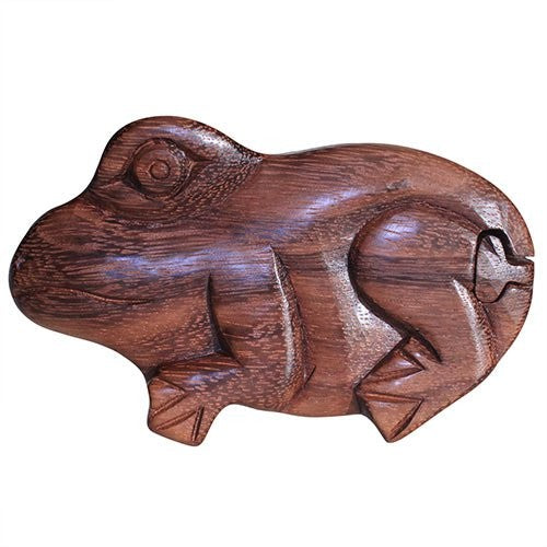 Wooden frog sculpture with simple, carved details lying on its side. The polished wood grain is visible, and the design is minimalistic, capturing the essence of the animal in an abstract form.