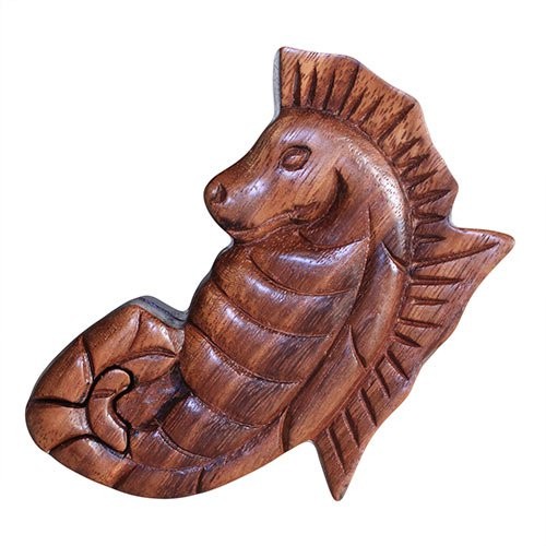 Wooden seahorse carving resting on a plain white background, showcasing intricate detailing with smooth curves and textured fins, conveying a sense of handcrafted artistry.