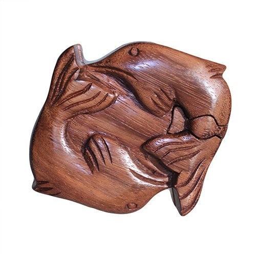 Wooden puzzle box shaped like two fish intertwined, carved with detailed fins and scales, set against a plain white background.