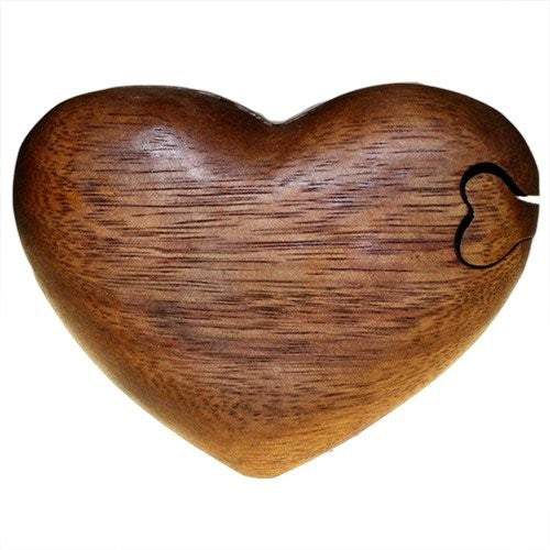 A wooden heart-shaped box with a small heart cutout is placed against a white background, emphasizing its smooth texture and natural grain.