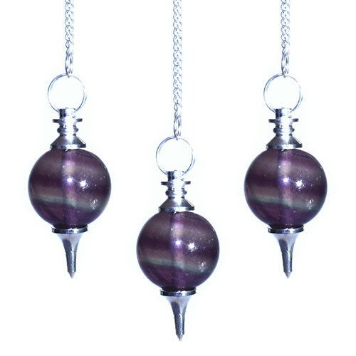 Three fluorite pendulums hang centered, each on a silver chain. The pendulums have a rounded stone body with purple and green banding and pointed silver ends, against a white background.