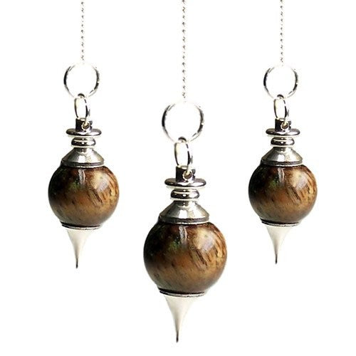 Three brown wooden and silver pendulums hang suspended against a white background, each attached to a fine silver chain.