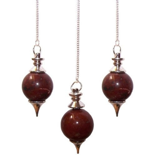 Three crystal pendulums hang in a row, each attached to a silver chain. The crystals are deep red and spherical with silver metal caps and pointed ends. The background is white.