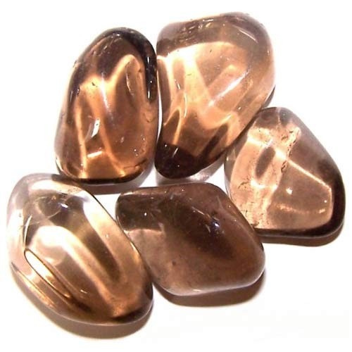 Five polished, translucent, brownish-grey stones sit on a white background. The stones are various sizes and shapes but are generally rounded and smooth.