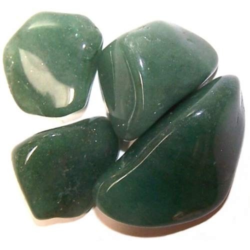 Four green polished stones sit clustered together on a white surface, reflecting light.