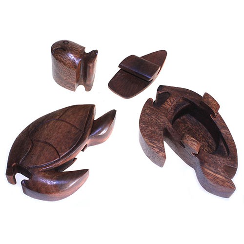 A wooden turtle puzzle is disassembled into four distinct pieces, each crafted to interlock, placed on a plain white surface.