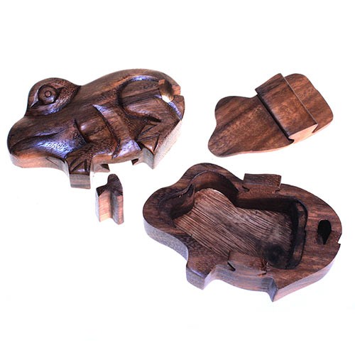 Wooden puzzle box shaped like a turtle, disassembled into four parts, against a white background. The box features a hollow interior, revealing its storage function.