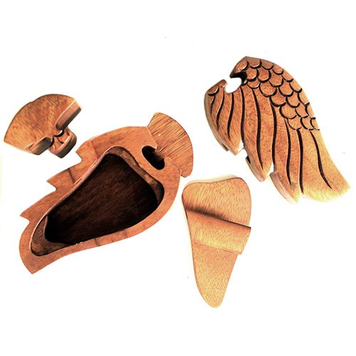 A wooden puzzle box, shaped like an eagle, is disassembled into five pieces, revealing a hollow interior. The context is a plain, white background.