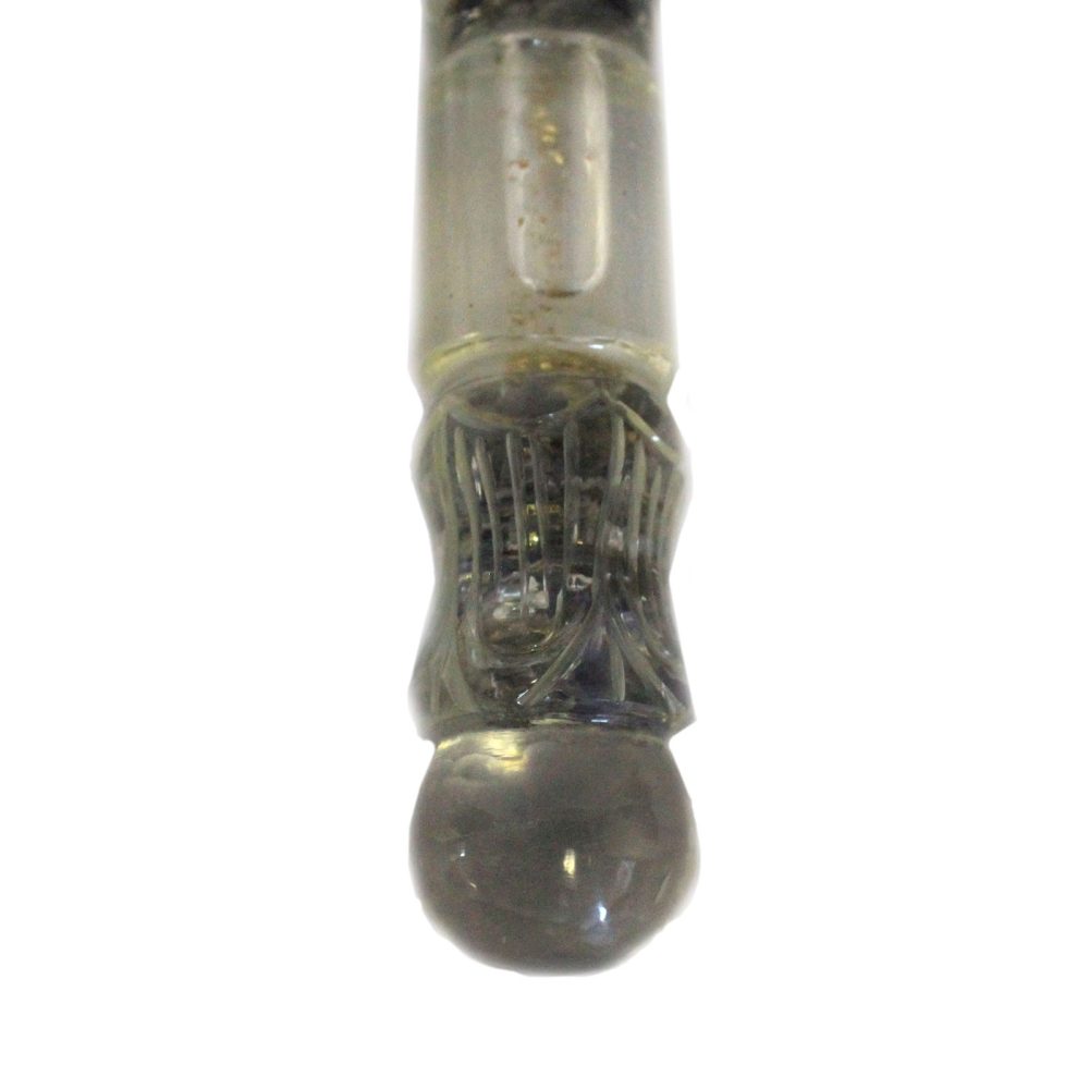 A clear, cylindrical object narrows to an elaborate, cage-like structure before terminating in a spherical base, all against a stark white background.