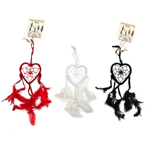 Three heart-shaped dream catchers hang, each with unique colored feathers: red, white, and black. Each features a small tag reading "Real Dream Catcher".