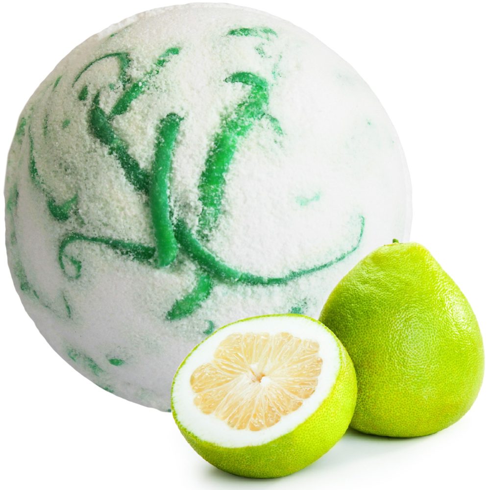 A large, spherical, icy white ball with green swirls sits next to two pomelo fruits, one whole and one halved, on a plain white background.