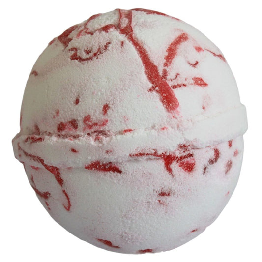 A white spherical bath bomb with red marbling rests on a plain background, showcasing a textured surface.