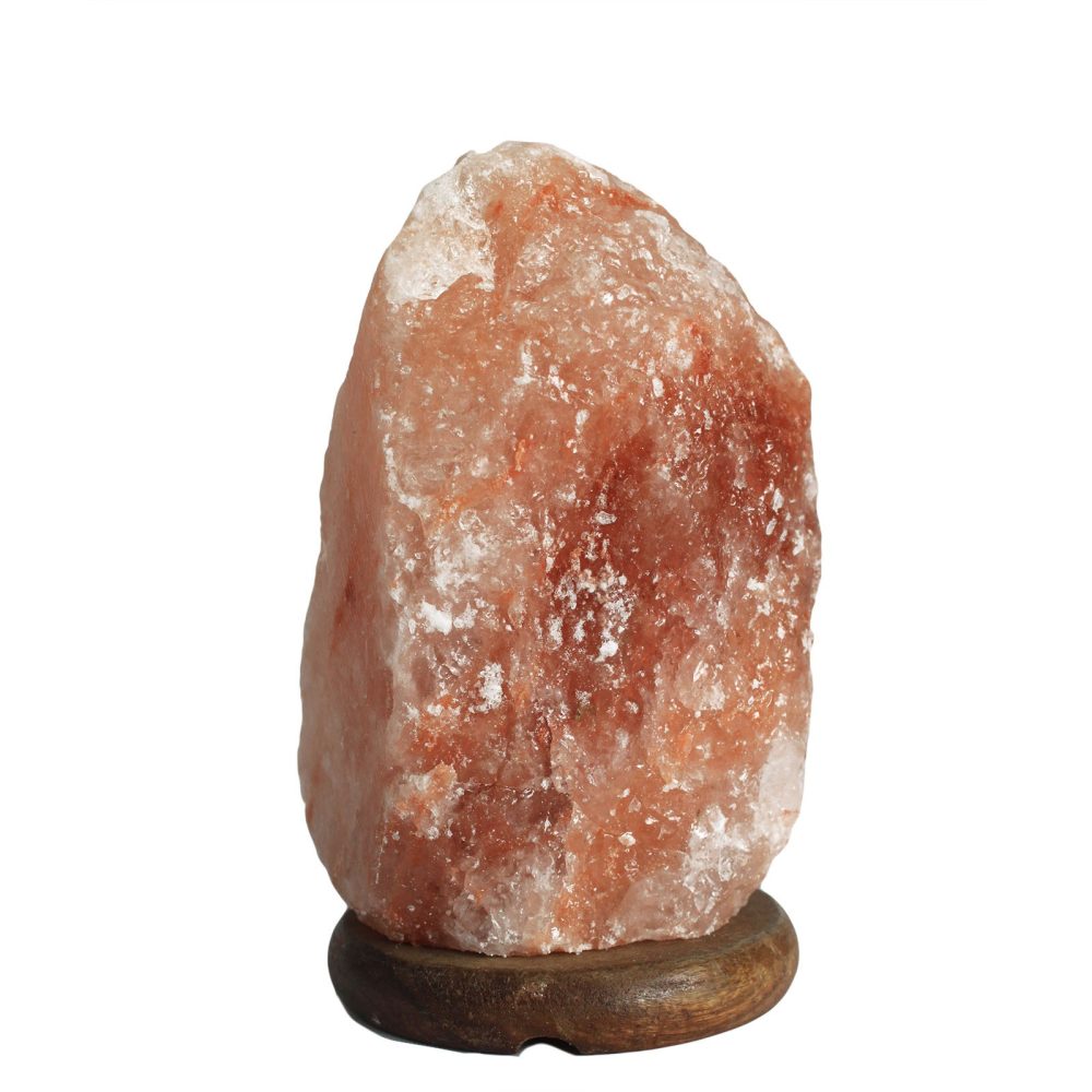 A large, irregularly shaped pink Himalayan salt rock sits on a small, round wooden base, isolated against a plain white background.
