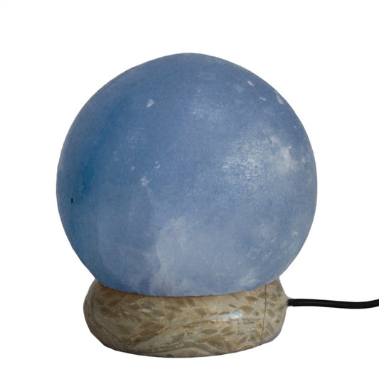 Round blue glass lampshade sits on a textured, beige stone base. A black power cord extends from the base, all set on a plain, white background.