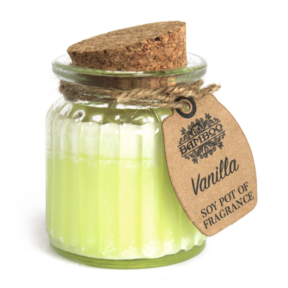 A candle in a clear, ridged jar is sealed with a cork lid and tied with twine. A tag reads "BAMBOO Vanilla SOY POT OF FRAGRANCE." The background is white.
