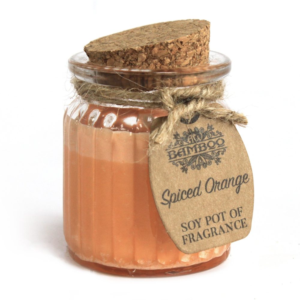 A jar of "Spiced Orange SOY POT OF FRAGRANCE" candle is seen on a white surface. The jar has a cork lid and twine and tag with "BAMBOO" brand is around its neck.