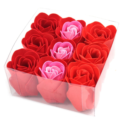 Clear plastic box holding twelve foam roses arranged in a 3x4 grid, mostly red with three pink centers, set against a white background.