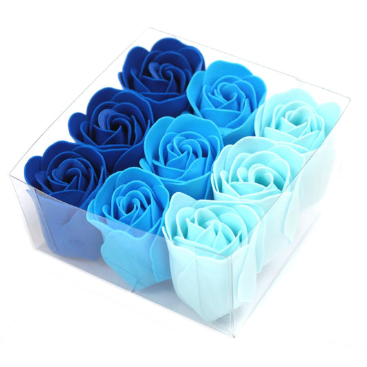 Nine foam roses arranged in a gradient from dark to light blue, packed in a clear plastic box on a white background.