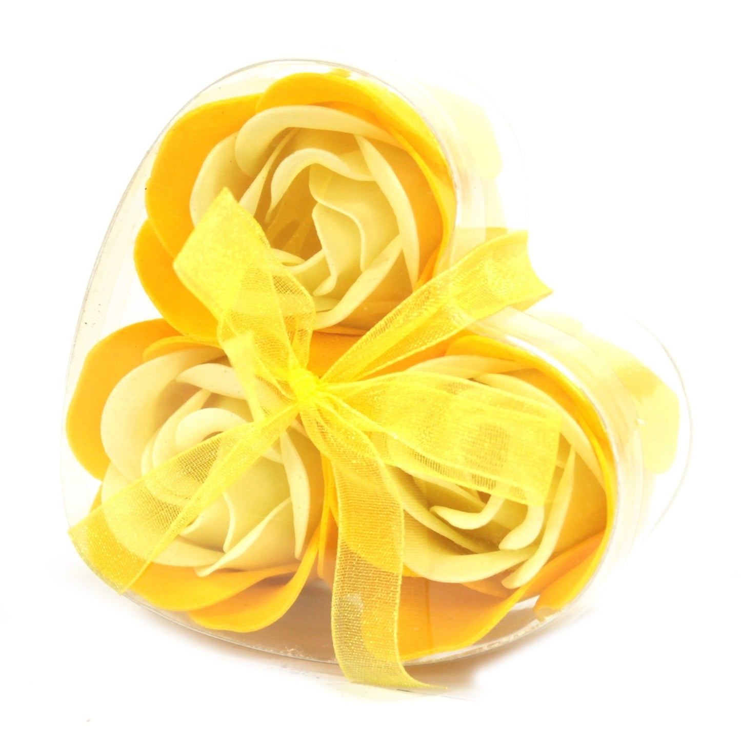 Artificial yellow roses fill a clear, heart-shaped box tied with a yellow ribbon, resting on a white background.