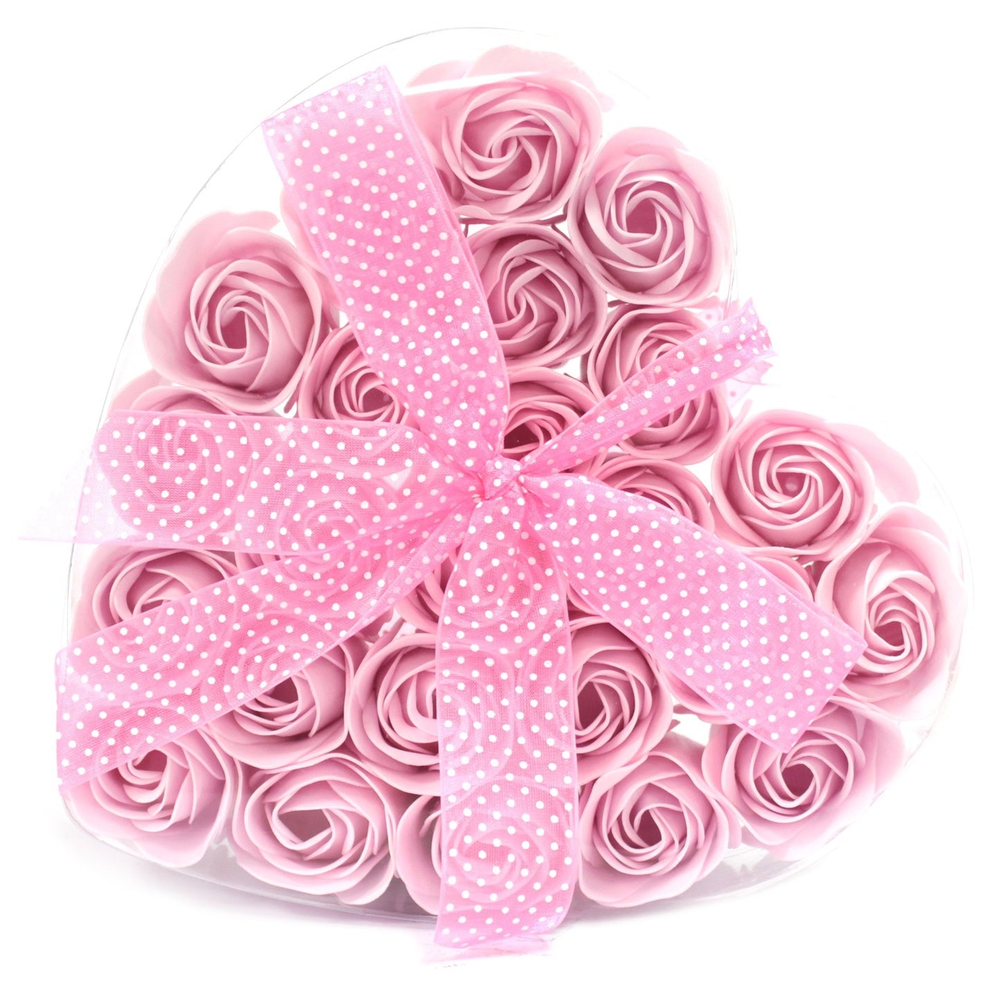 A heart-shaped box contains pink rose-shaped soap and is tied with a light pink polka-dot ribbon. The context is a plain white background.