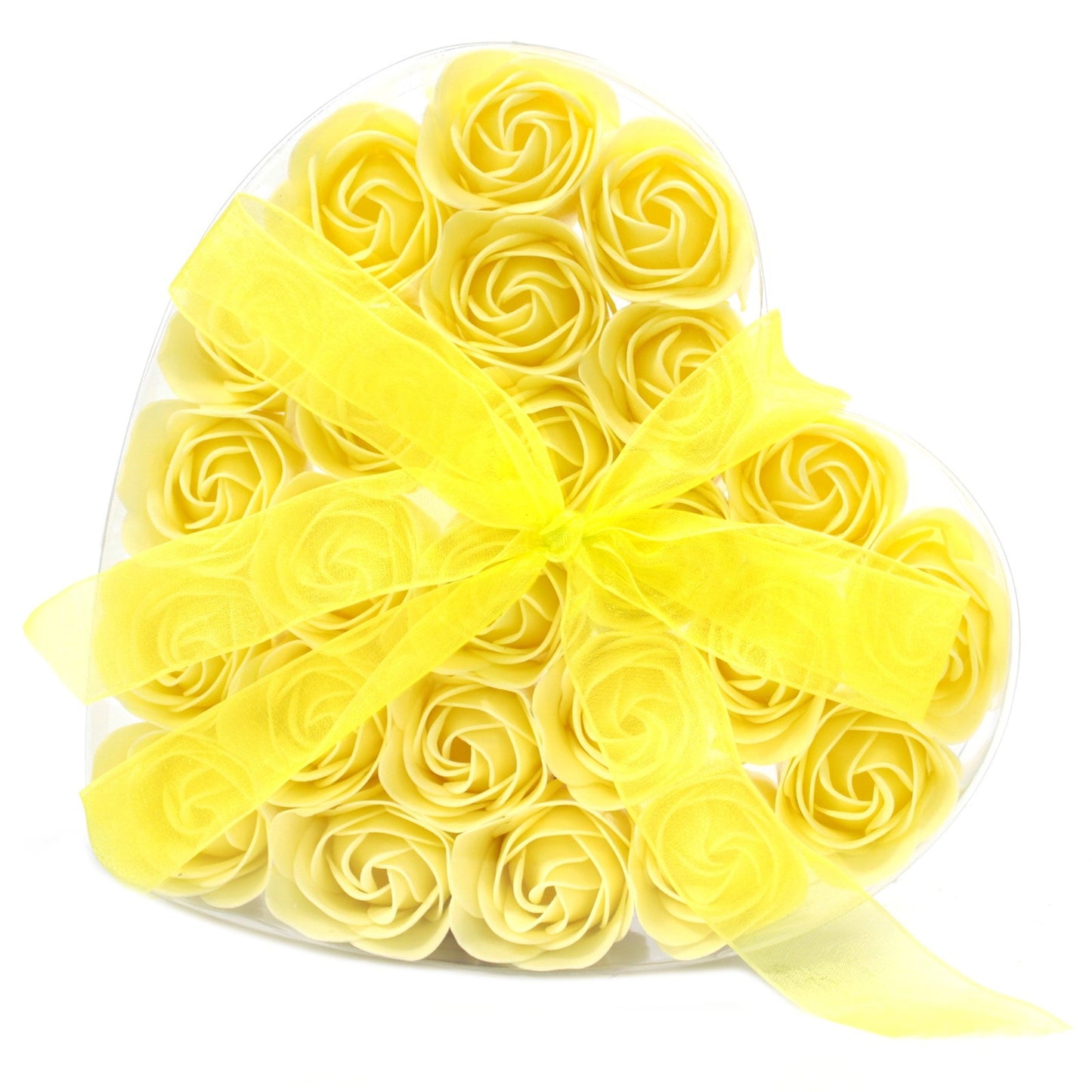 Yellow soap roses rest in a clear, heart-shaped container, accented with a yellow, translucent ribbon tied into a bow. This is on a white background.