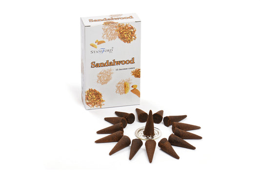 Incense cones form a circle around a metal holder. A nearby box labeled "Stamford Sandalwood 15 incense cones" features sandalwood imagery, providing a fragrant context.