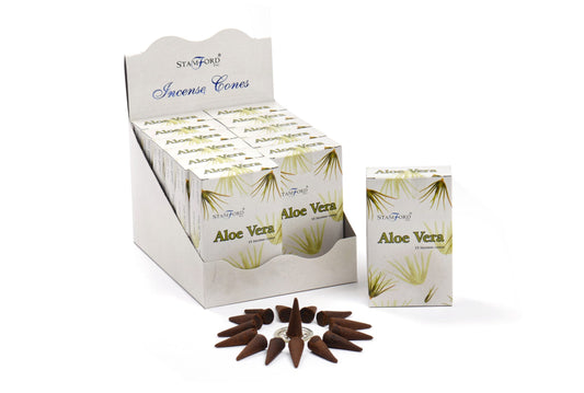 An open display box containing multiple smaller boxes labeled "Stamford Aloe Vera Incense Cones." Outside the box, a circle of brown incense cones is arranged around a metal holder.