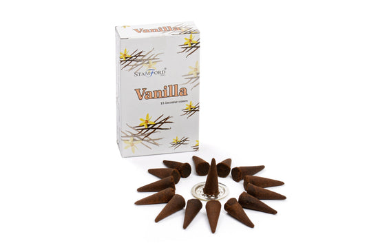 Incense cones are arranged in a circle around a metal holder. The box beside them reads "Stamford Incense Cones Vanilla," with vanilla flowers and sticks illustrated on it.