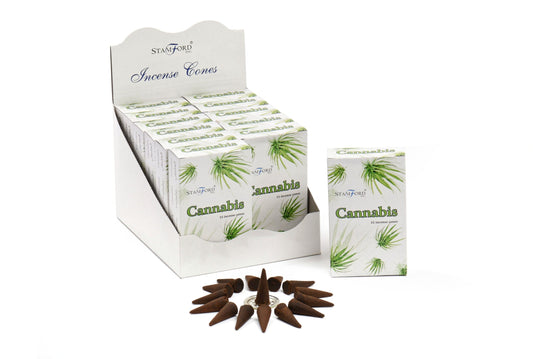 A display box contains multiple packs labeled "Stamford Incense Cones Cannabis." Packs show green leaf graphics. In front, arranged incense cones are placed in a circle on a white surface.