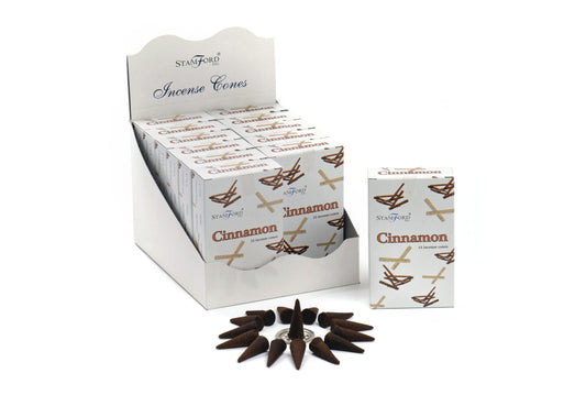 Boxes of Stamford cinnamon incense cones are displayed in a white cardboard holder. A single box is placed in front alongside a circle of loose incense cones. Text: "Stamford Incense Cones Cinnamon 15 incense cones."