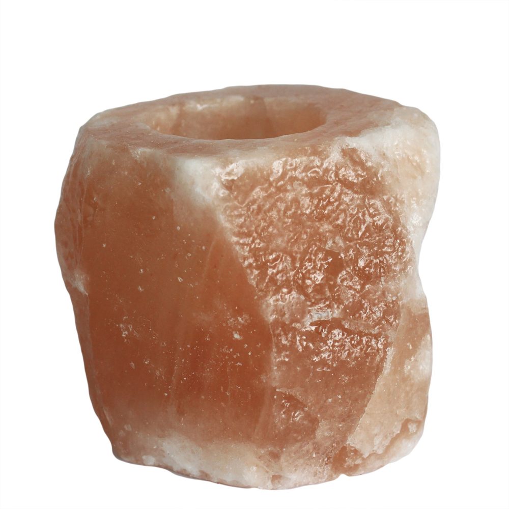A rough, pink Himalayan salt candle holder with a hollowed center is positioned against a plain white background. The salt's crystalline texture is clearly visible.