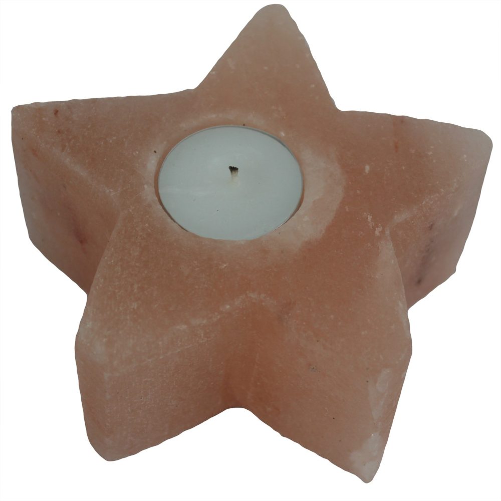 A star-shaped, pink salt lamp holds a small, white tea light candle in its center. The object is set against a stark white background.