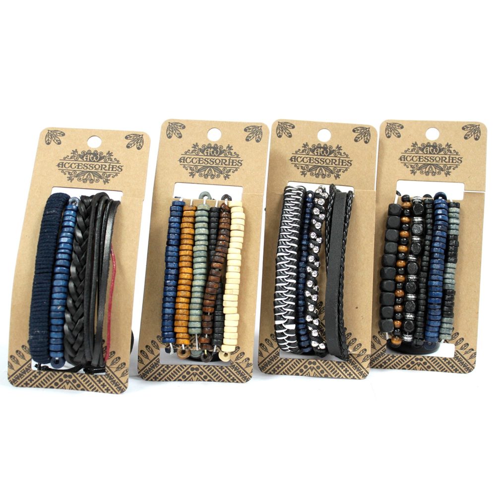 Four "ACCESSORIES" branded bracelets are displayed on decorative cardboard backing. The bracelets feature a variety of styles, including braided leather and beads of various colors. They sit on a white surface.