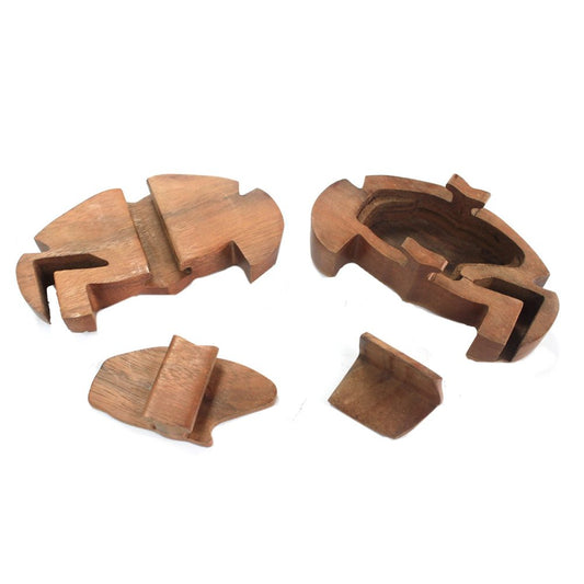 Wooden puzzle pieces are separated, displaying an inner compartment. The pieces are shaped like a fish and are arranged on a white background.