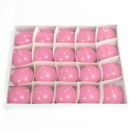Pink spherical candles are arranged five-by-four in a white compartmentalized box resting on a white surface.