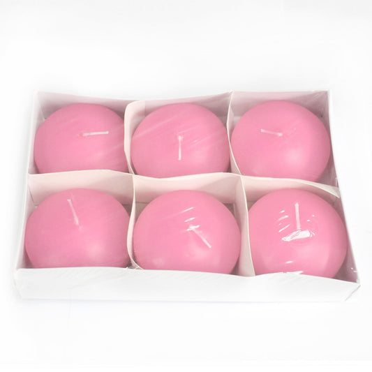 Six round pink candles sit arranged in a white six-compartment tray, each candle under clear plastic on a white background.