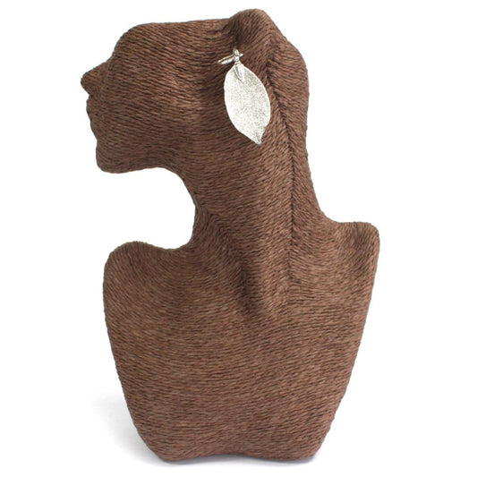 A silver leaf earring is displayed on a brown mannequin bust against a white backdrop.