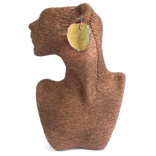 A hemp-wrapped mannequin wears a leaf-shaped earring. The earring dangles from the ear of the mannequin, set against a clean, white background.