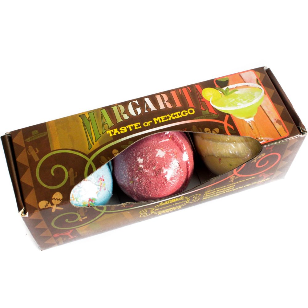 Box containing three colorful bath bombs. Text reads "MARGARITA TASTE of MEXICO." Packaging features a margarita illustration and decorative Mexican-themed patterns, against a brown background with yellow accents.