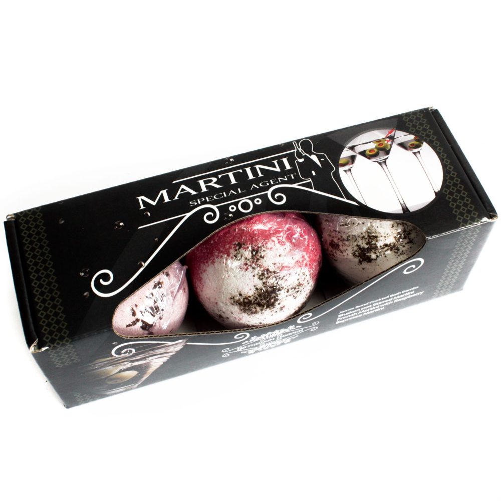 A black box labeled "MARTINI SPECIAL AGENT" contains three speckled, spherical bath bombs. The packaging features an image of martini glasses with olives, set against a white background.