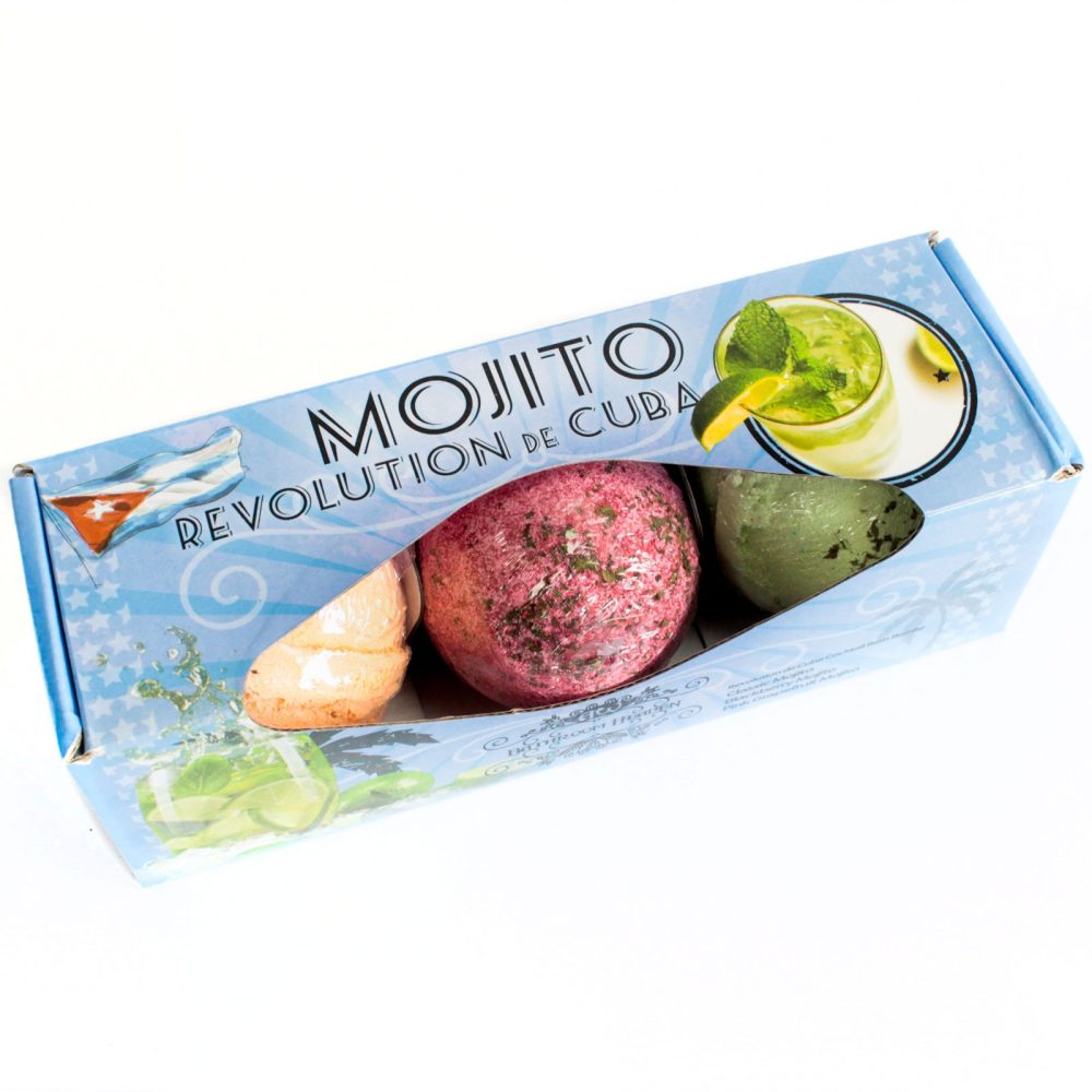 Box containing three colorful bath bombs, set against a blue packaging with "MOJITO REVOLUTION de CUBA" text and images of a mojito and the Cuban flag for decoration.