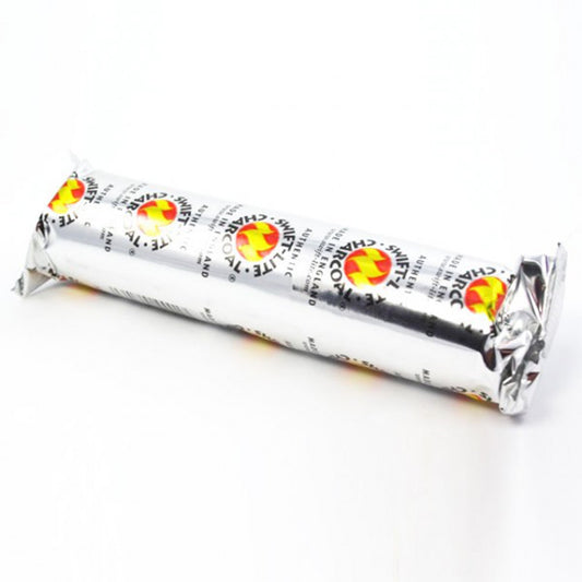 A cylindrical foil-wrapped package labeled "SWIFT-LITE CHARCOAL," featuring a flame logo, rests on a white surface. The text includes "MADE IN ENGLAND" and "AUTHENTIC."