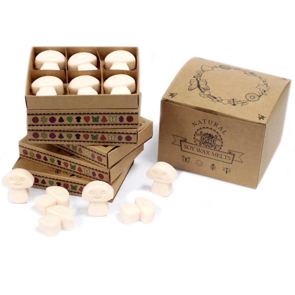 Mushroom-shaped soy wax melts are packaged in a stack of decorated boxes, next to a larger gift box that reads, “NATURAL SOY WAX MELTS”.
