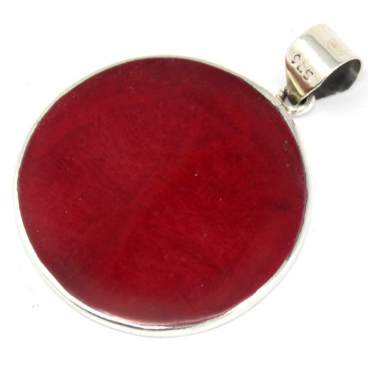 A round, red pendant with a silver border and bail sits on a white surface. "925" is stamped on the bail.
