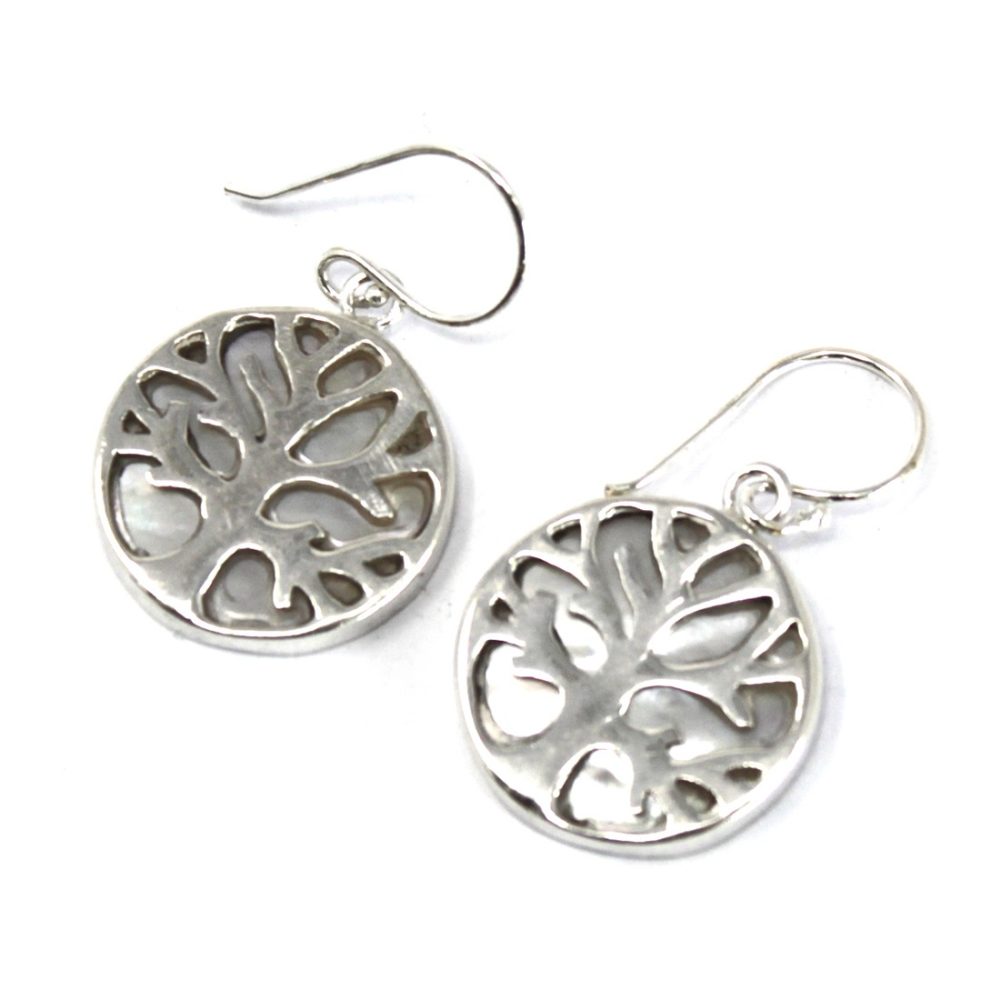 Two silver dangle earrings display a stylized "Tree of Life" design inside a circular frame, suspended from curved, delicate hooks against a white background.