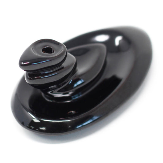 A smooth, black ceramic incense holder shaped like a swirled cone rests on an oval base, designed to hold incense cones, against a plain, white background.